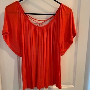 Red orange flowy short sleeve shirt.